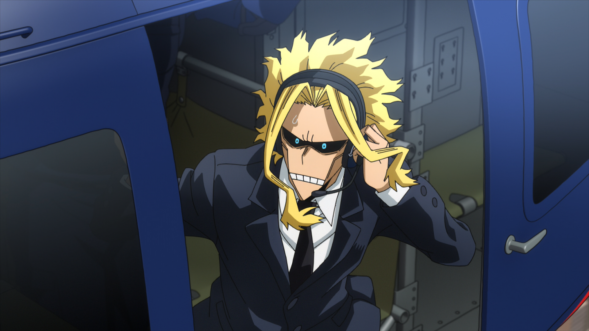 All Might from My Hero Academia: You're Next, depicted in a sleek suit, confidently communicating as he emerges from a blue vehicle. A striking HD wallpaper for fans.