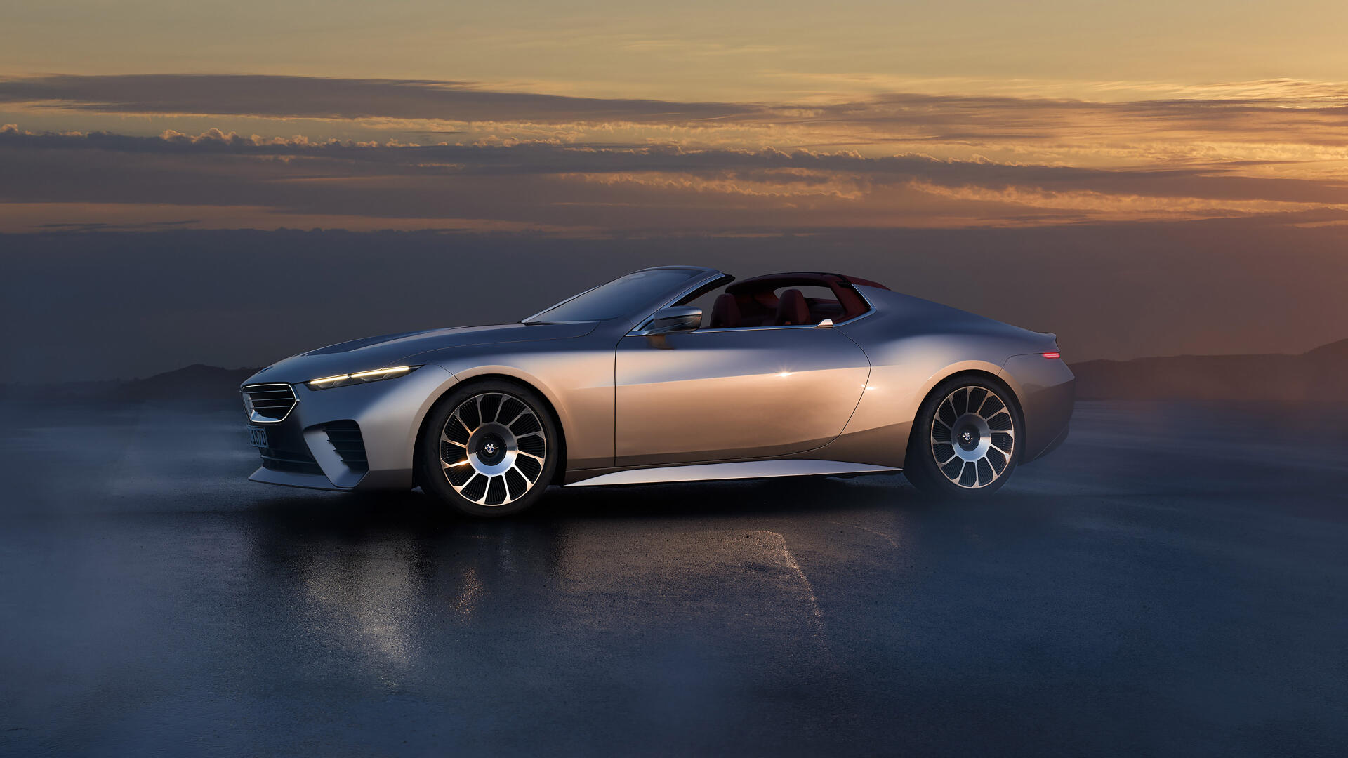 A sleek BMW Skytop car is showcased in this stunning 4K Ultra HD wallpaper, set against a dramatic sunset background. The vehicle's design highlights luxury and performance.