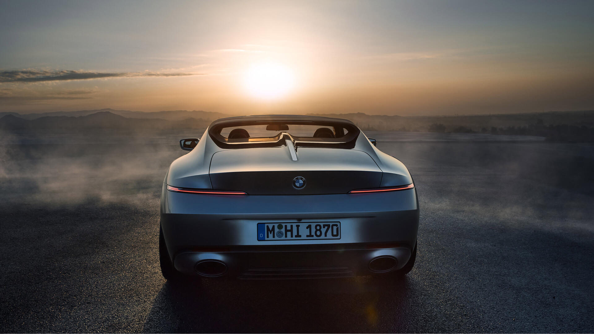 A BMW Skytop convertible is showcased against a stunning sunset, creating a dramatic backdrop for this 4K Ultra HD desktop wallpaper.