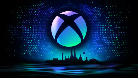 A vibrant HD desktop wallpaper featuring the Xbox logo against a cosmic backdrop, with a silhouette of a cityscape, capturing the essence of Gamescom and modern technology.