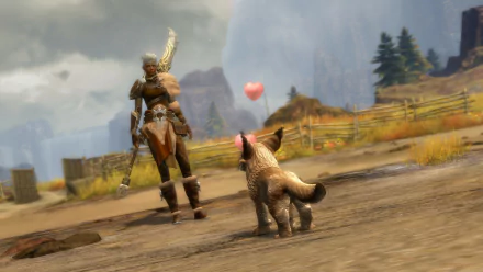 A warrior stands in the Janthir Wilds of Guild Wars 2, gazing down at a playful creature, with mountains and a heart-shaped balloon in the background, creating a vibrant HD desktop wallpaper.