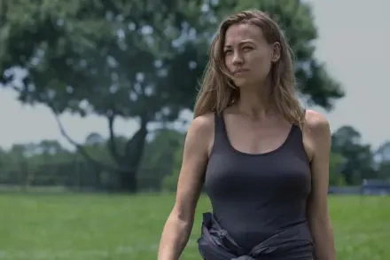 Yvonne Strahovski walking through a grassy field in a scene from the TV show Teacup (2024). This 8K Ultra HD image serves as a striking PC desktop wallpaper.