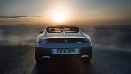 A BMW Skytop convertible is showcased against a stunning sunset, creating a dramatic backdrop for this 4K Ultra HD desktop wallpaper.