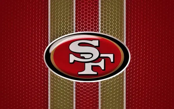 San Francisco 49ers logo on a vibrant red and gold background, featuring a textured design, captures the spirit of NFL football in a high-definition desktop wallpaper.