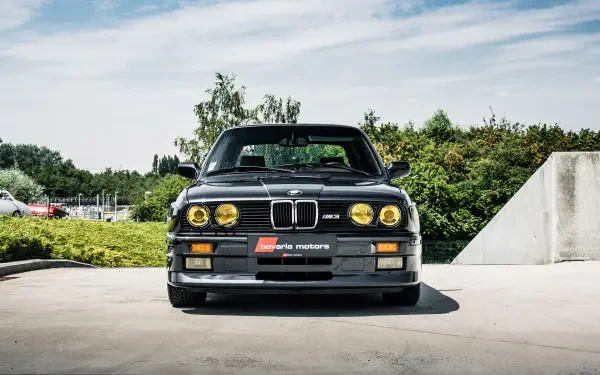 A striking BMW E30 M3 stands prominently, showcasing its classic design and features. This HD image serves as an impressive desktop wallpaper and background for car enthusiasts.