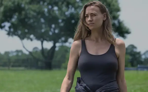 Yvonne Strahovski walking through a grassy field in a scene from the TV show Teacup (2024). This 8K Ultra HD image serves as a striking PC desktop wallpaper.