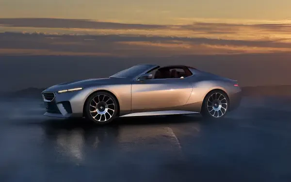 A sleek BMW Skytop car is showcased in this stunning 4K Ultra HD wallpaper, set against a dramatic sunset background. The vehicle's design highlights luxury and performance.
