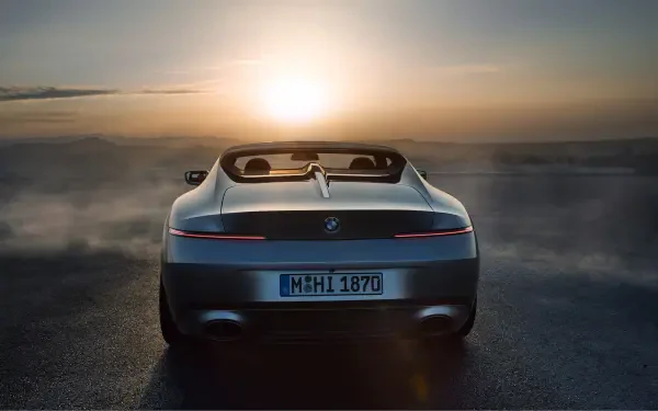 A BMW Skytop convertible is showcased against a stunning sunset, creating a dramatic backdrop for this 4K Ultra HD desktop wallpaper.