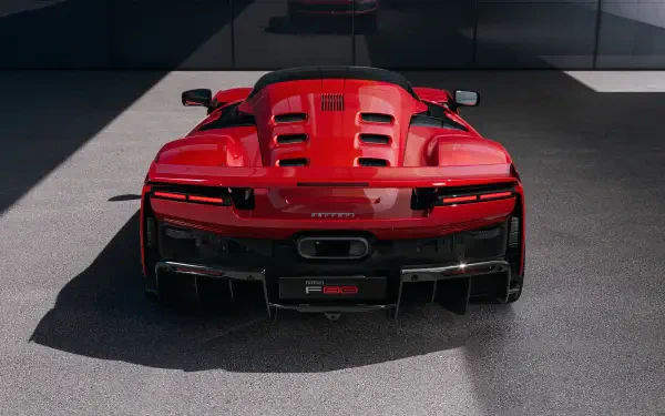 Rear view of a red Ferrari F80 showcased in an 8K Ultra HD PC desktop wallpaper, highlighting the vehicle's sleek and aggressive design.