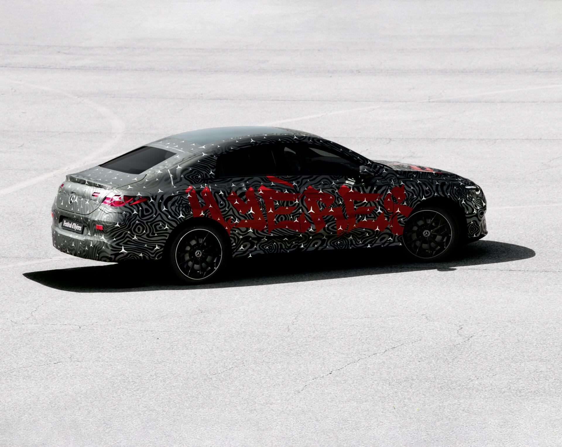 A Mercedes-Benz CLA, featuring a vibrant design with bold patterns, is showcased in this HD wallpaper, capturing its sleek profile against a minimalist background.