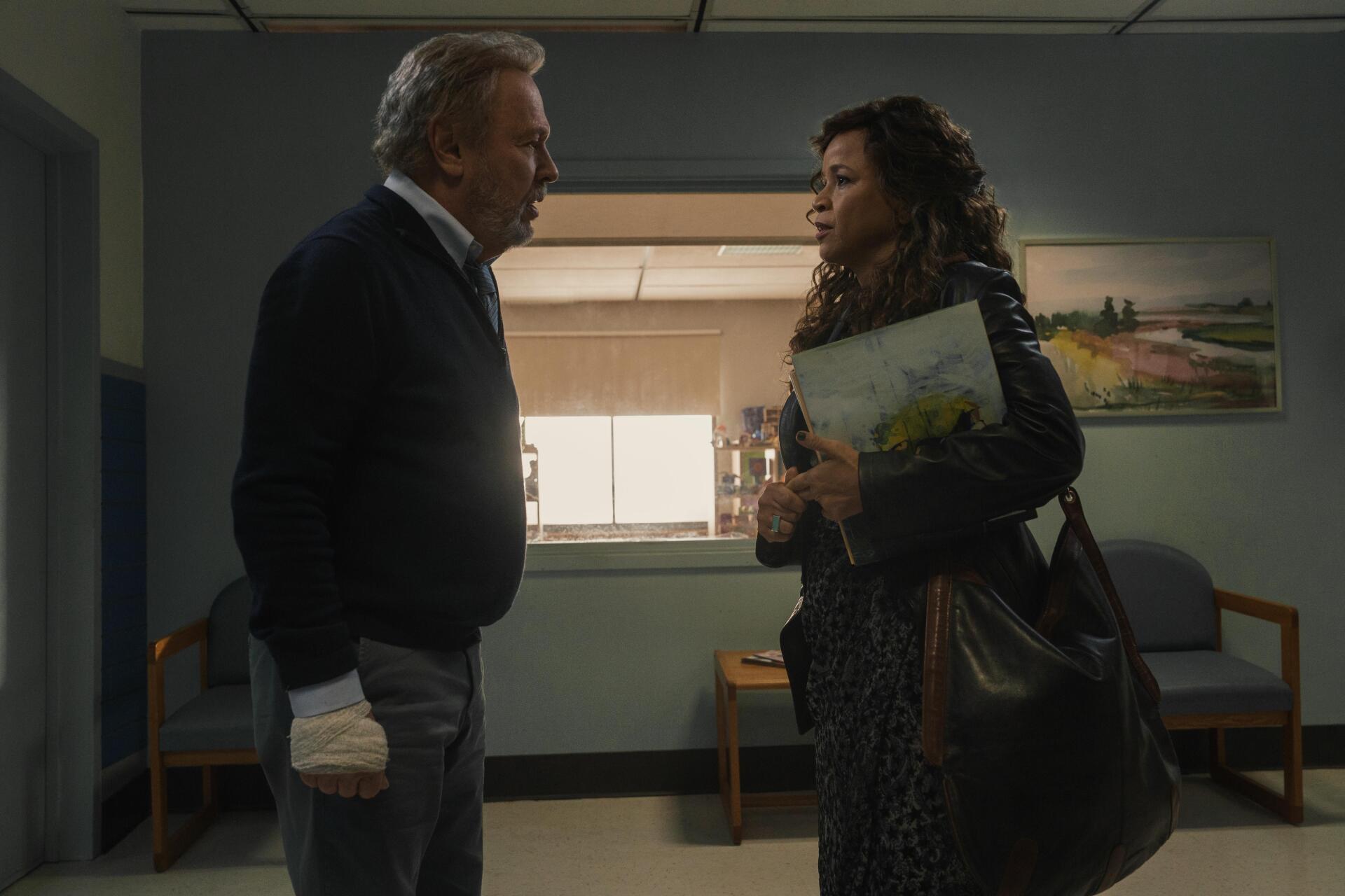A moment from the TV show Before (2024), featuring Billy Crystal and Rosie Perez, set in a hospital waiting area, conveying tension and emotion. 4K Ultra HD desktop wallpaper.
