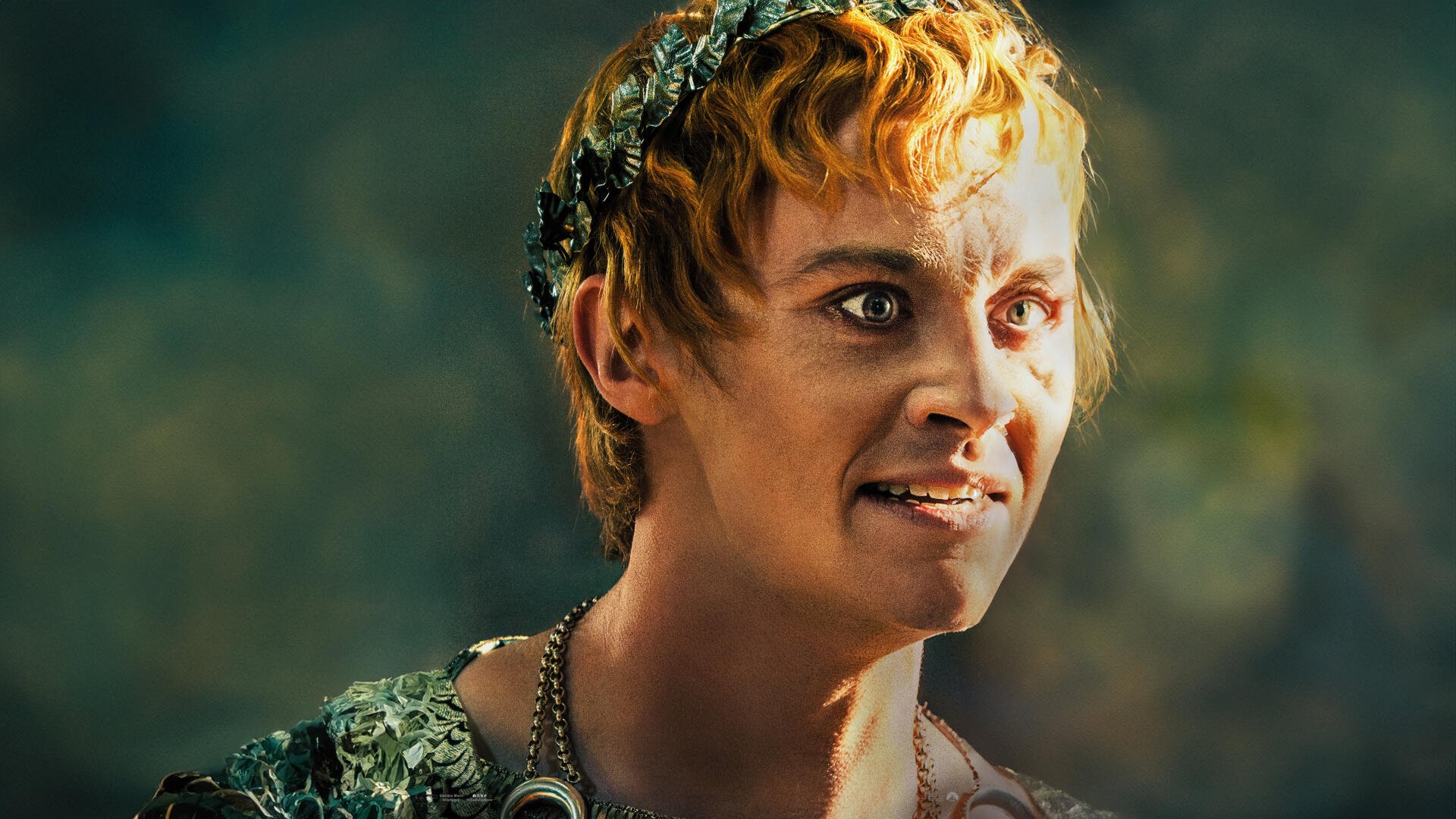 A close-up of Joseph Quinn in character for Gladiator II, showcasing vibrant details in his costume and expressive features in this 4K Ultra HD movie wallpaper.