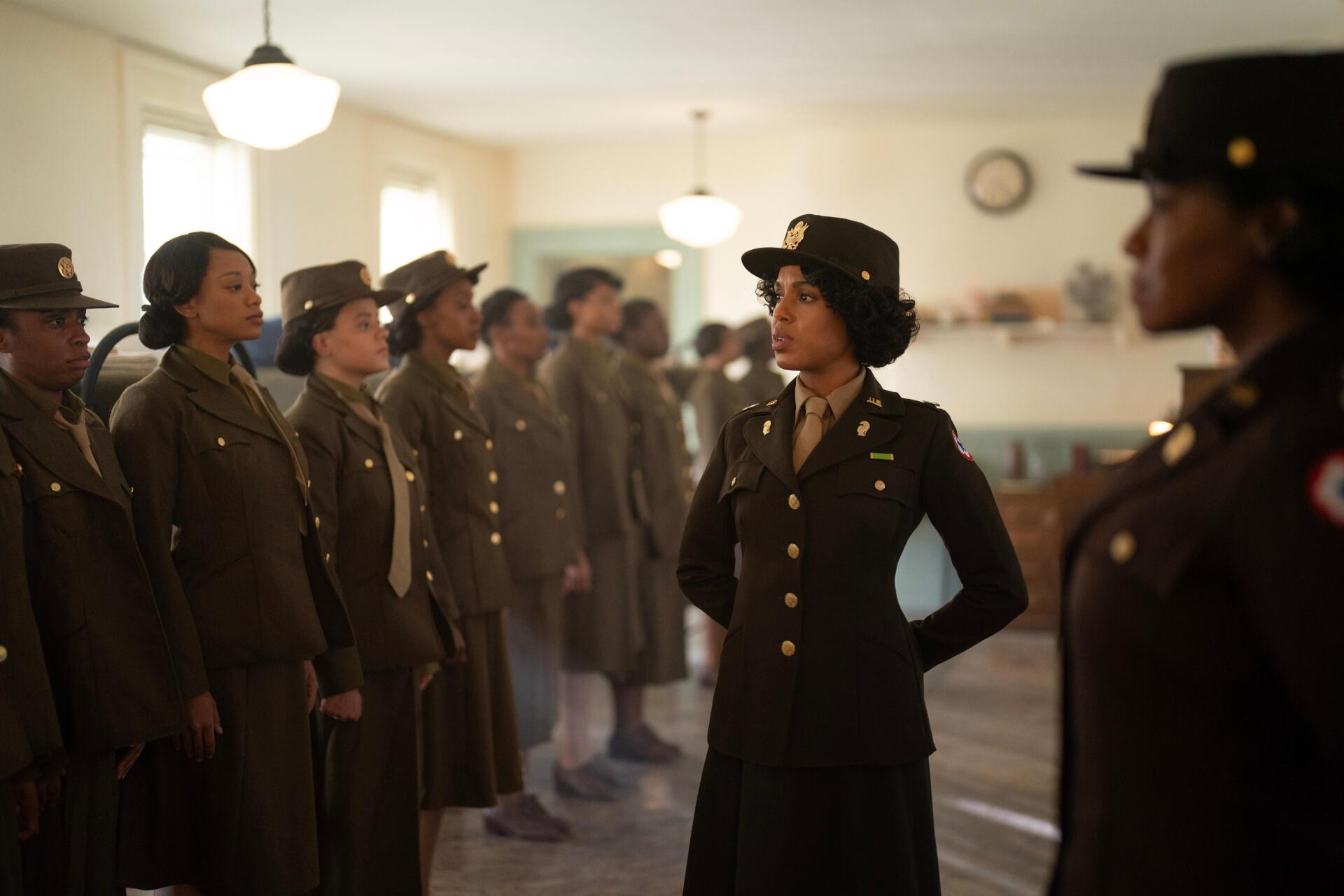 A scene from the movie The Six Triple Eight, featuring Kerry Washington in uniform, surrounded by fellow soldiers in a historic setting. 4K Ultra HD background wallpaper.