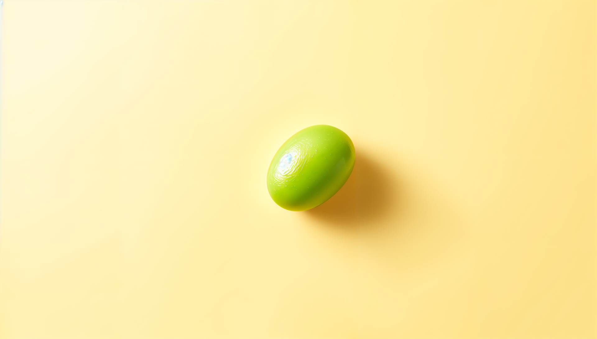 A vibrant green lentil sits against a soft yellow background, creating a striking visual contrast, designed as a 4K Ultra HD PC desktop wallpaper.