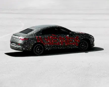 A Mercedes-Benz CLA, featuring a vibrant design with bold patterns, is showcased in this HD wallpaper, capturing its sleek profile against a minimalist background.