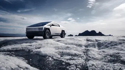 A Tesla Cybertruck stands out prominently against a dramatic landscape, showcasing its futuristic design in this stunning 4K Ultra HD desktop wallpaper.
