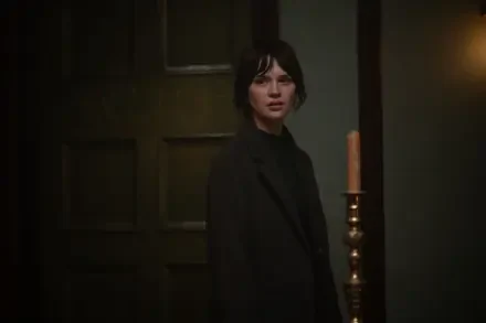 A scene from the movie Heretic (2024), featuring Sophie Thatcher, showcasing a tense moment in a dimly lit room with a candlelit ambiance. 4K Ultra HD wallpaper.