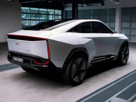 HD desktop wallpaper featuring the sleek, futuristic Mahindra BE 09 car in a modern indoor setting.