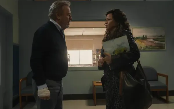 A moment from the TV show Before (2024), featuring Billy Crystal and Rosie Perez, set in a hospital waiting area, conveying tension and emotion. 4K Ultra HD desktop wallpaper.