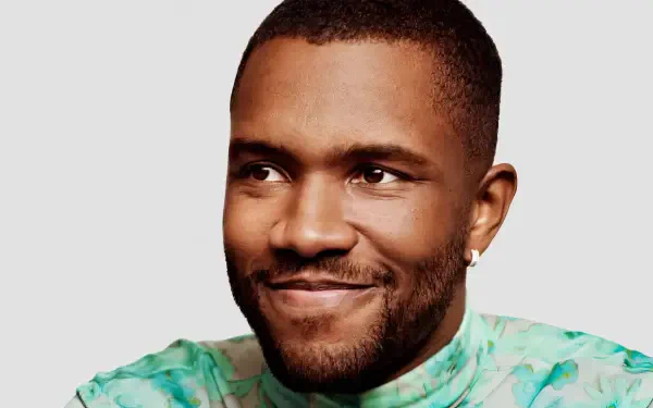 A vibrant HD desktop wallpaper featuring Frank Ocean, smiling and wearing a colorful shirt, embodying the essence of music and artistry.