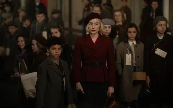A scene from the movie Blitz (2024), featuring Saoirse Ronan in a striking red coat, leads a group of children in a historical setting, highlighting themes of resilience and unity.