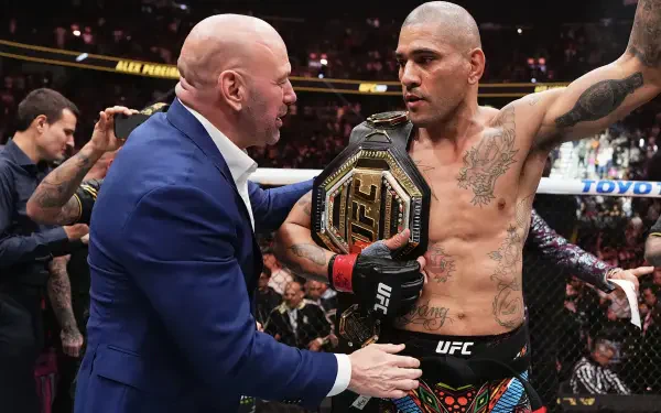Alex Pereira celebrates with his championship belt in the UFC octagon, receiving praise from a figure in a suit, highlighting the excitement of MMA sports. HD desktop wallpaper.