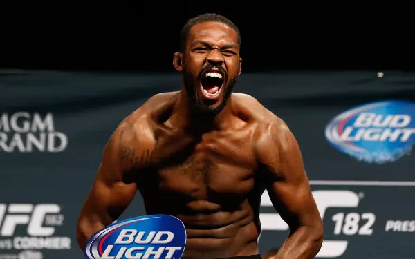 HD PC desktop wallpaper featuring UFC and MMA fighter Jon Jones celebrating intensely with a dark background showcasing UFC and sponsor logos.