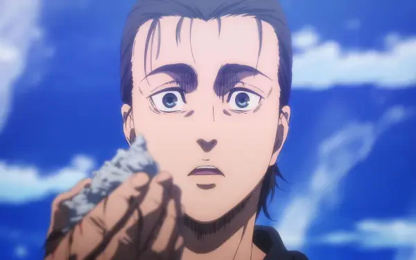 Eren Yeager from Attack on Titan: The Last Attack gazes intently while holding a small piece of rock, set against a backdrop of clear blue skies. HD anime wallpaper.