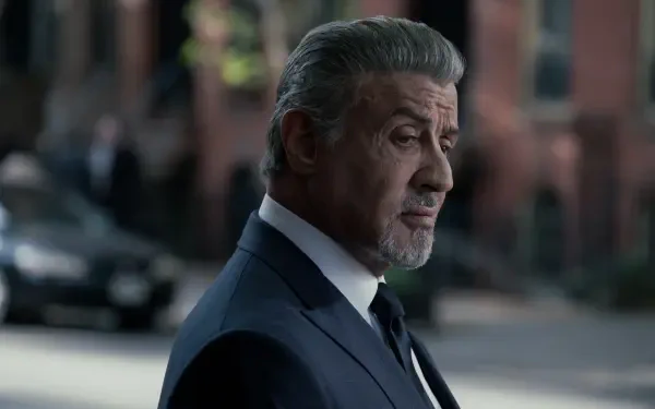 A side profile of Sylvester Stallone in a suit, captured in a scene from the TV show Tulsa King, showcasing a cinematic moment in striking 4K Ultra HD detail.