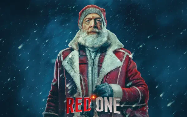 A striking 4K Ultra HD wallpaper featuring a weathered figure in a red coat and hat against a snowy backdrop, representing the movie Red One.