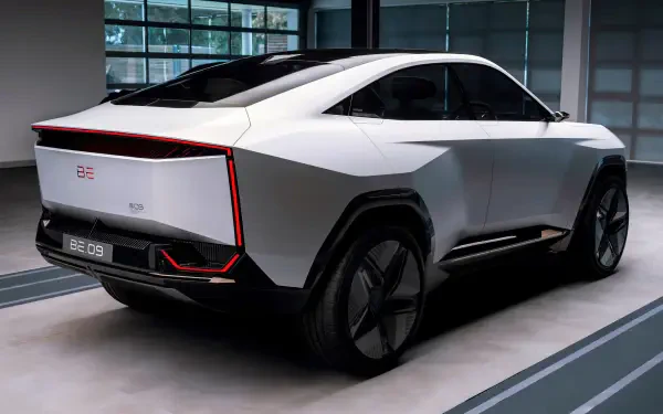 HD desktop wallpaper featuring the sleek, futuristic Mahindra BE 09 car in a modern indoor setting.