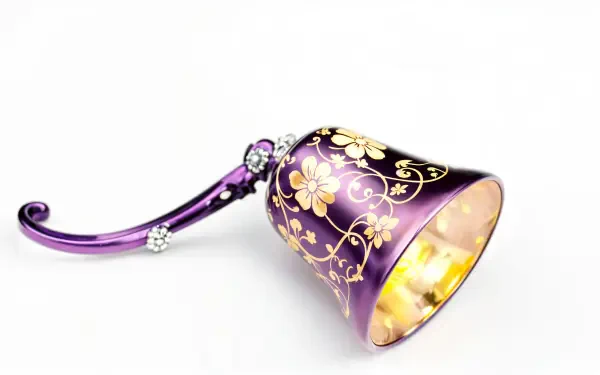 A beautifully designed purple bell with floral patterns, set against a clean background, captured in stunning 4K Ultra HD for a captivating PC desktop wallpaper.