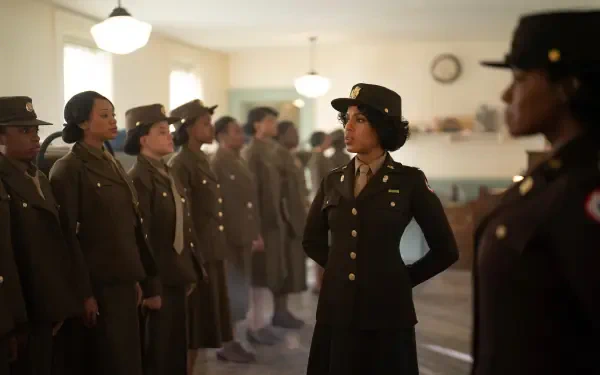 A scene from the movie The Six Triple Eight, featuring Kerry Washington in uniform, surrounded by fellow soldiers in a historic setting. 4K Ultra HD background wallpaper.