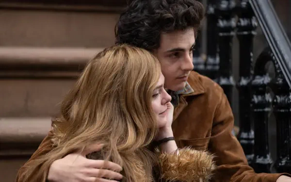 A scene from the movie A Complete Unknown featuring Timothée Chalamet and Elle Fanning, captured in 8K Ultra HD, showcasing a moment of intimacy on a staircase.