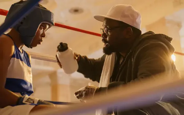 A scene from the movie *The Fire Inside*, showcasing a boxer and his coach in a moment of focus and preparation, captured as a striking 4K Ultra HD desktop wallpaper.