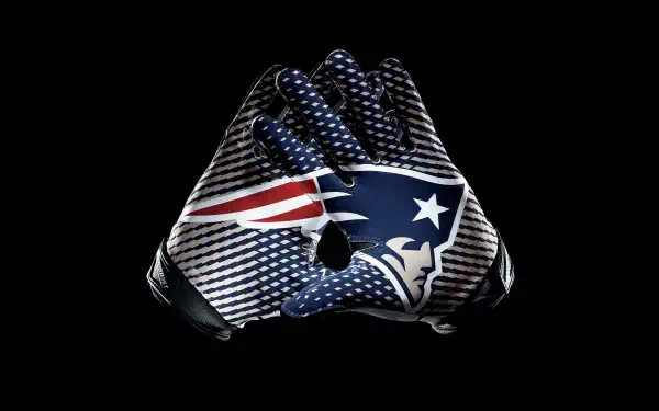 An impressive 8K Ultra HD wallpaper featuring a New England Patriots football glove, showcasing the team's colors and logo against a sleek black background.