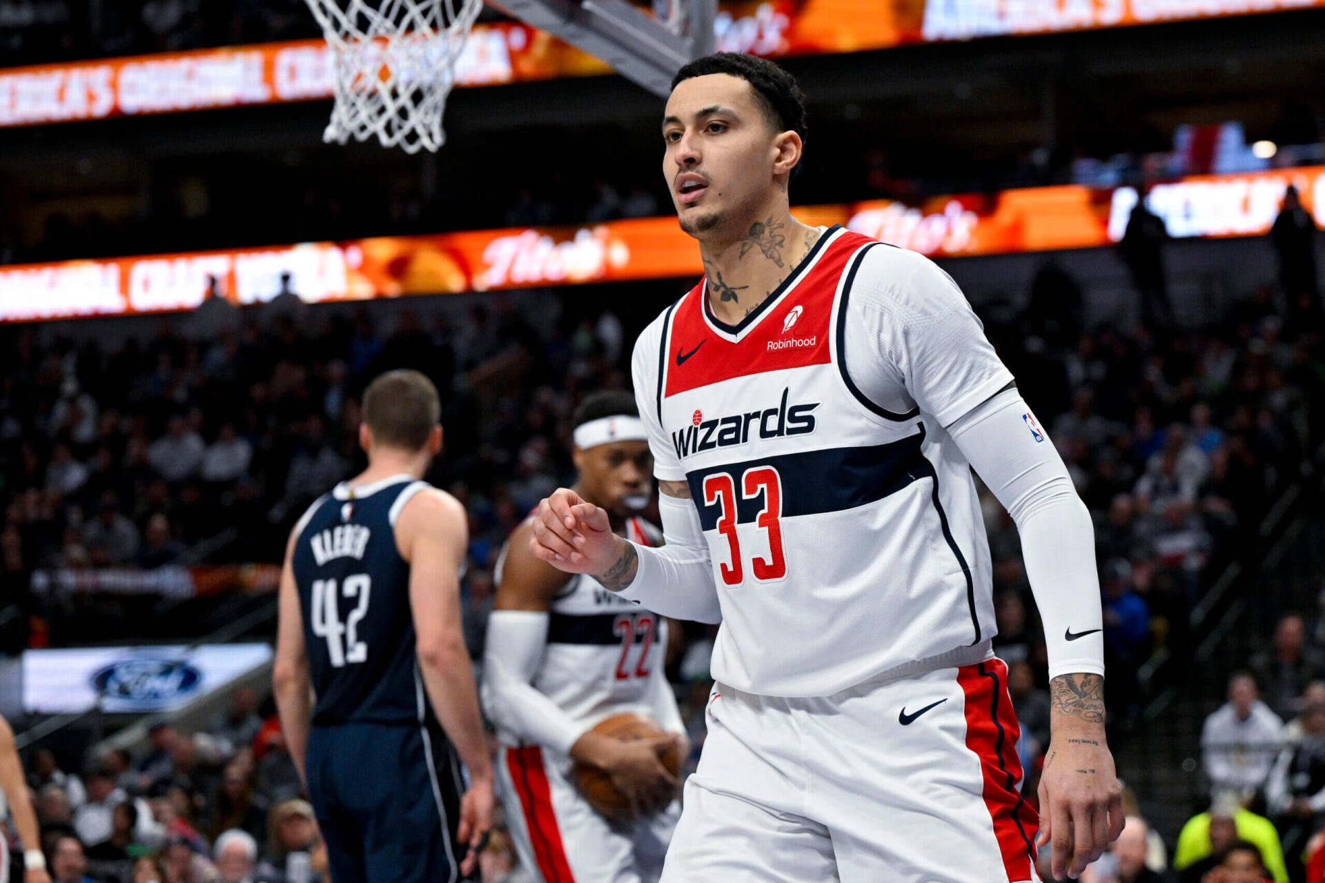 Kyle Kuzma of the Washington Wizards celebrates on the court during an NBA game, showcasing his athleticism in a dynamic basketball scene. A vibrant HD wallpaper for sports fans.