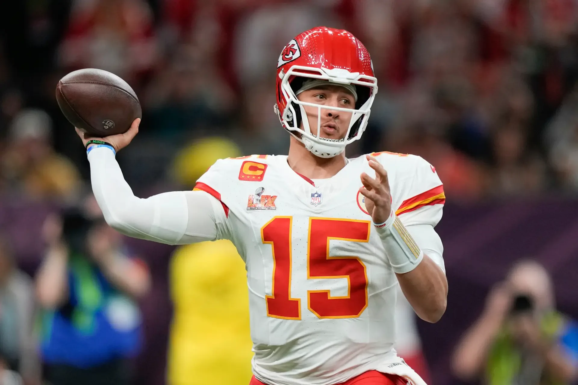 Patrick Mahomes of the Kansas City Chiefs throws a football during an NFL game, captured in a vibrant 4K Ultra HD background.