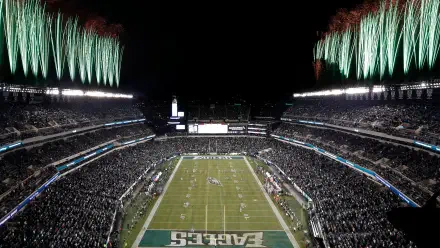 A vibrant view of the Philadelphia Eagles' stadium during a night game, filled with fans and illuminated by fireworks, showcasing the excitement of NFL football.