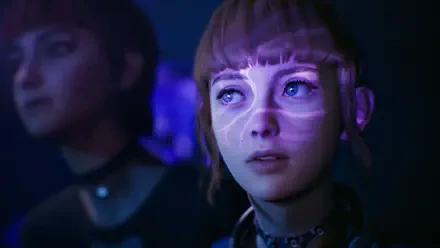 A HD wallpaper from the video game Lost Records: Bloom & Rage, featuring a close-up of a girl with striking visuals projected on her face, set against a moody backdrop.