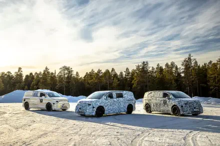 Three camouflaged Mercedes-Benz MPVs lined up on a snowy landscape, showcasing their sleek designs against a backdrop of trees and a clear sky.