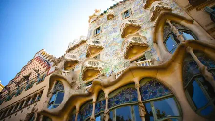 HD desktop wallpaper of the man-made architectural masterpiece Casa Batlló in Barcelona, Spain, showcasing its intricate design and colorful facade.