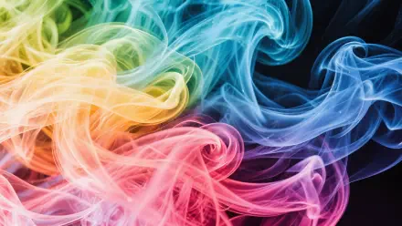 Vibrant swirling colorful smoke in red, yellow, green, and blue hues against a dark background, captured in stunning 4K Ultra HD for a dynamic PC desktop wallpaper.