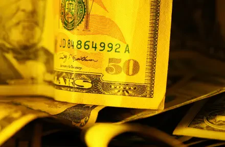 HD PC desktop wallpaper: close-up of American currency — a golden-toned fifty-dollar banknote atop stacked dollar bills (money, banknote).