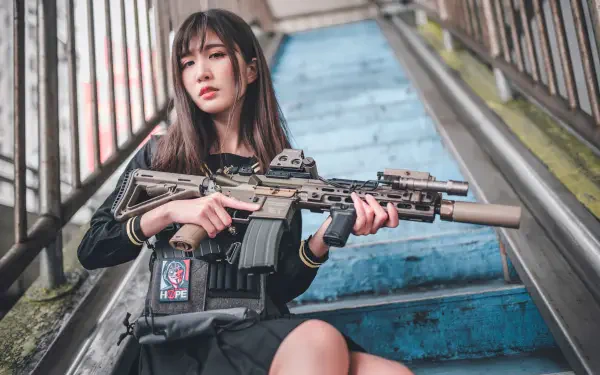 Asian woman seated on worn blue stairs holding a tactical rifle, cinematic 5K Ultra HD PC desktop wallpaper background.