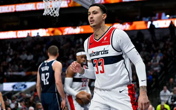 Kyle Kuzma of the Washington Wizards celebrates on the court during an NBA game, showcasing his athleticism in a dynamic basketball scene. A vibrant HD wallpaper for sports fans.