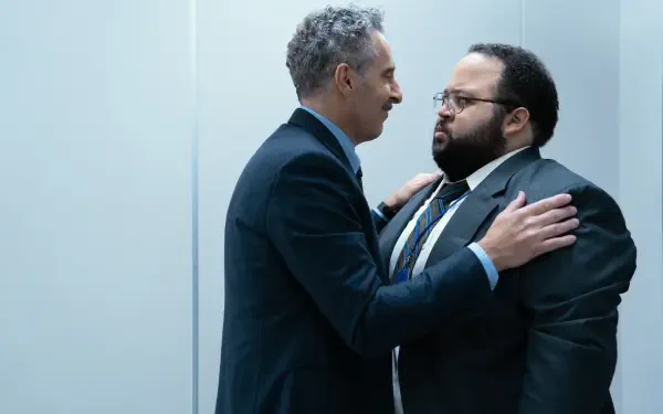 A scene from the TV show Severance, featuring John Turturro and Zach Cherry in a tense moment, showcasing their characters in a sleek, modern office setting. 4K Ultra HD wallpaper.