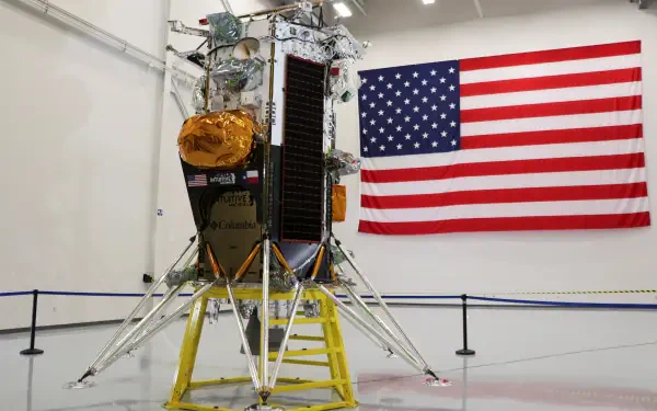 A menacing lunar lander by Intuitive Machines stands in front of an American flag, showcasing advanced technology and national pride. 4K Ultra HD wallpaper for space enthusiasts.