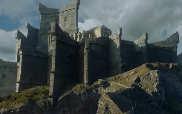 A dramatic landscape featuring a formidable castle perched on rocky cliffs, set against a moody sky, inspired by the TV show Game of Thrones. High-definition desktop wallpaper.