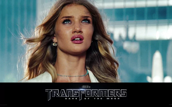 HD PC desktop wallpaper featuring a close-up of a female character from the movie Transformers: Dark of the Moon with the film’s logo beneath.
